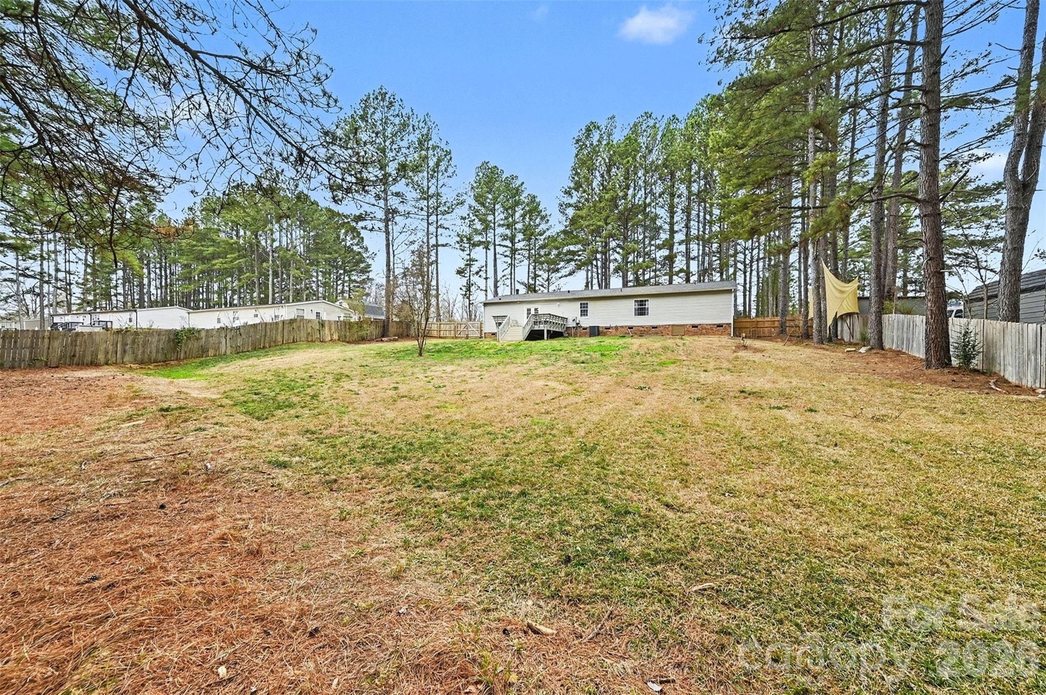 5018 Duncan Road Monroe, NC 28110 - Photo 29 of 33 a swimming pool with trees in front of it