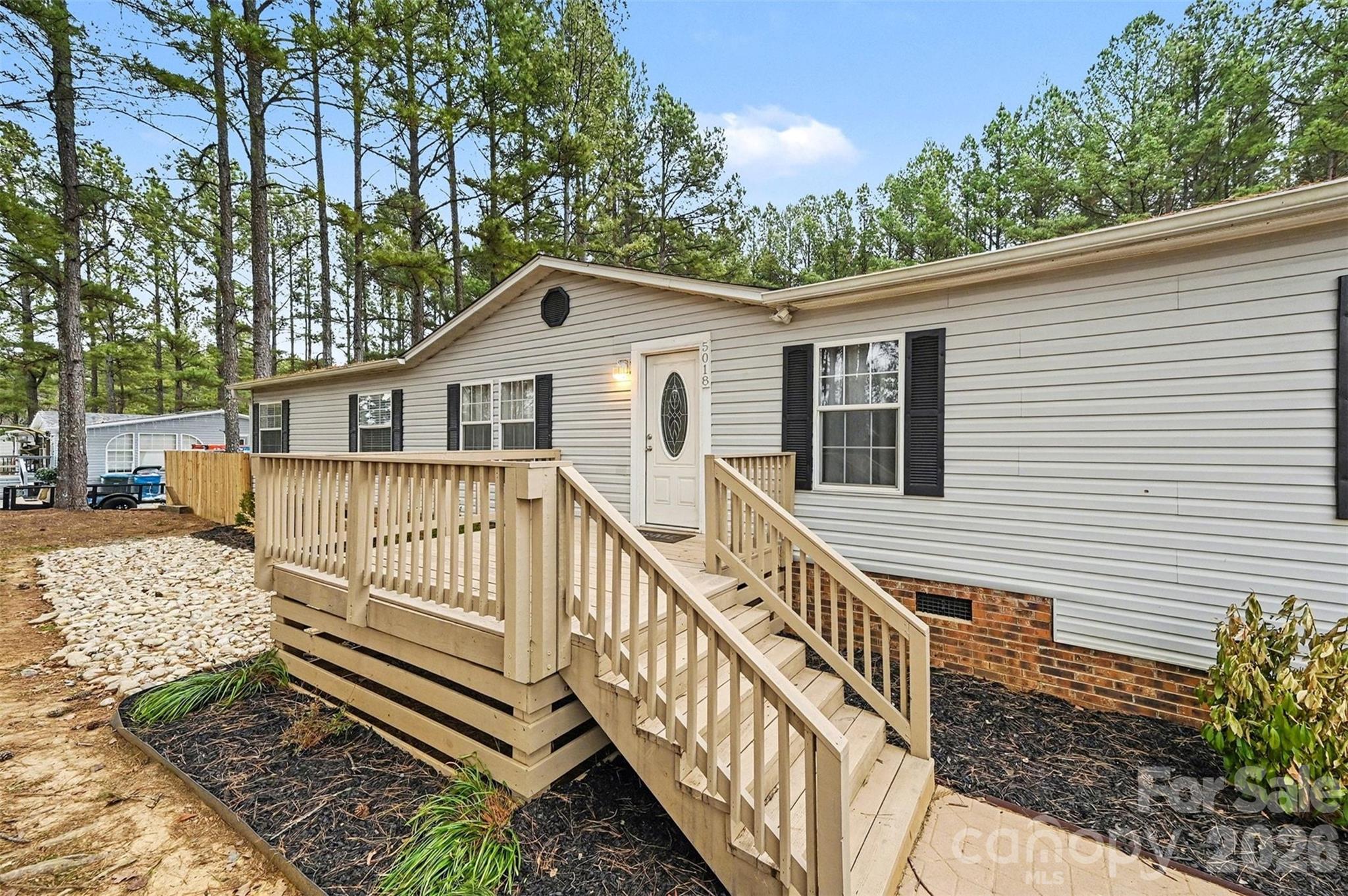 5018 Duncan Road Monroe, NC 28110 - Photo 6 of 33 a view of a house with a small yard and wooden fence