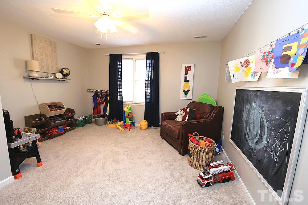 5029 Denham Court Raleigh, NC 27613 - Photo 11 of 13 a room with toys and a chandelier