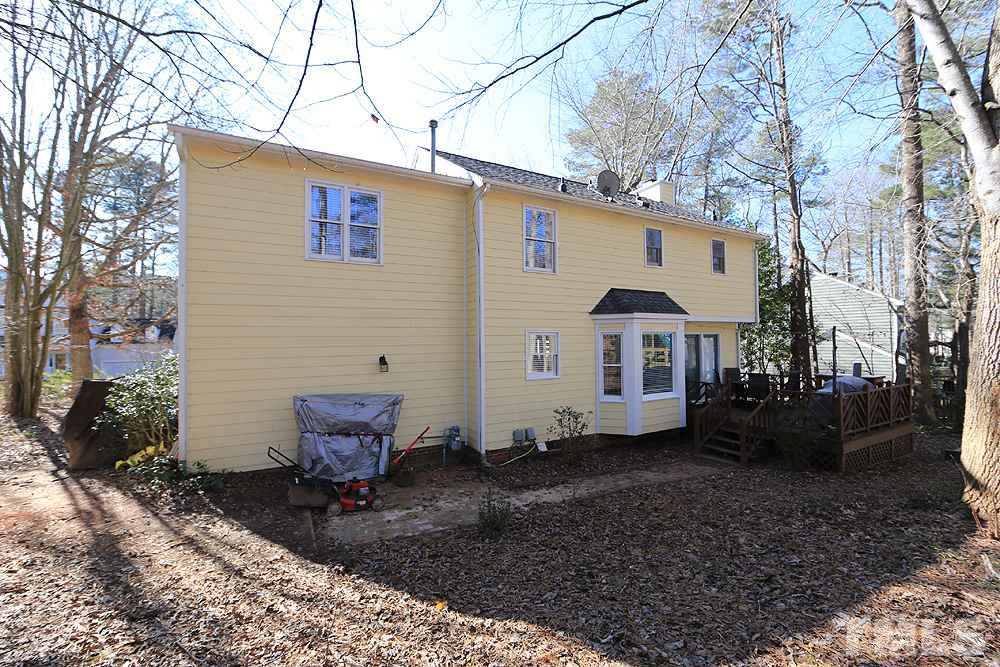 5029 Denham Court Raleigh, NC 27613 - Photo 13 of 13 a view of a small house with yard and sitting area