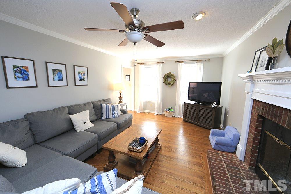 5029 Denham Court Raleigh, NC 27613 - Photo 3 of 13 a living room with furniture fireplace and a flat screen tv
