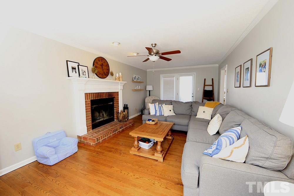 5029 Denham Court Raleigh, NC 27613 - Photo 4 of 13 a living room with furniture and a fireplace