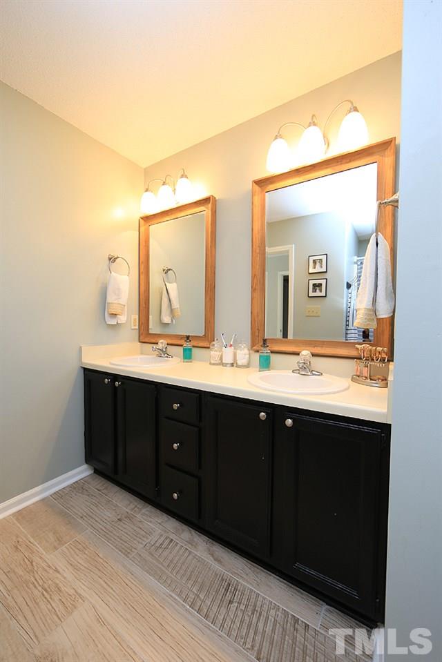 5029 Denham Court Raleigh, NC 27613 - Photo 8 of 13 a bathroom with a sink vanity and mirror