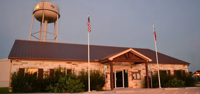 a front view of a house with backyard and glass door