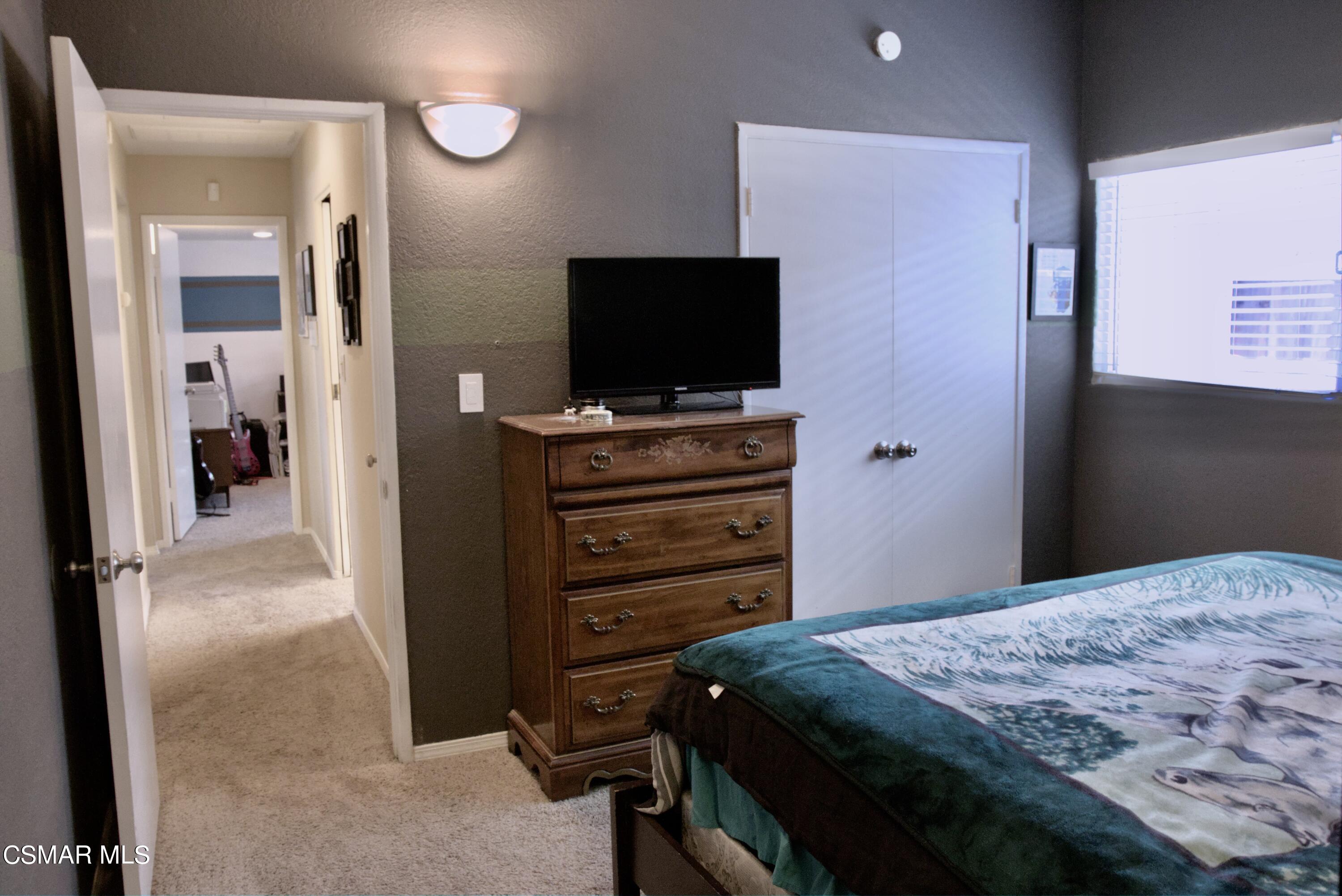4306 Shopping Lane Simi Valley, CA 93063 - Photo 11 of 15 a bedroom with a bed and a flat screen tv