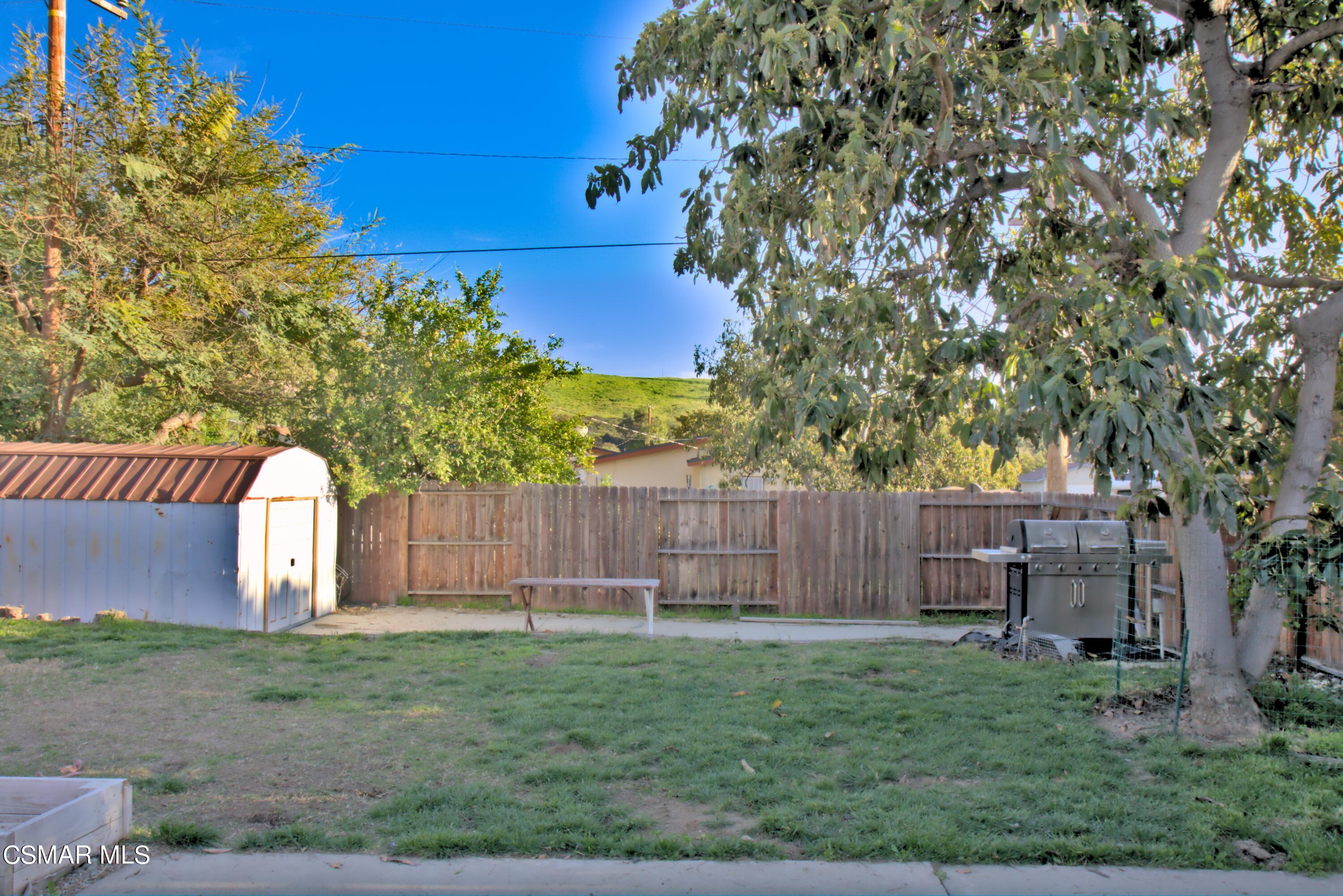 4306 Shopping Lane Simi Valley, CA 93063 - Photo 15 of 15 a view of a backyard with large trees and wooden fence