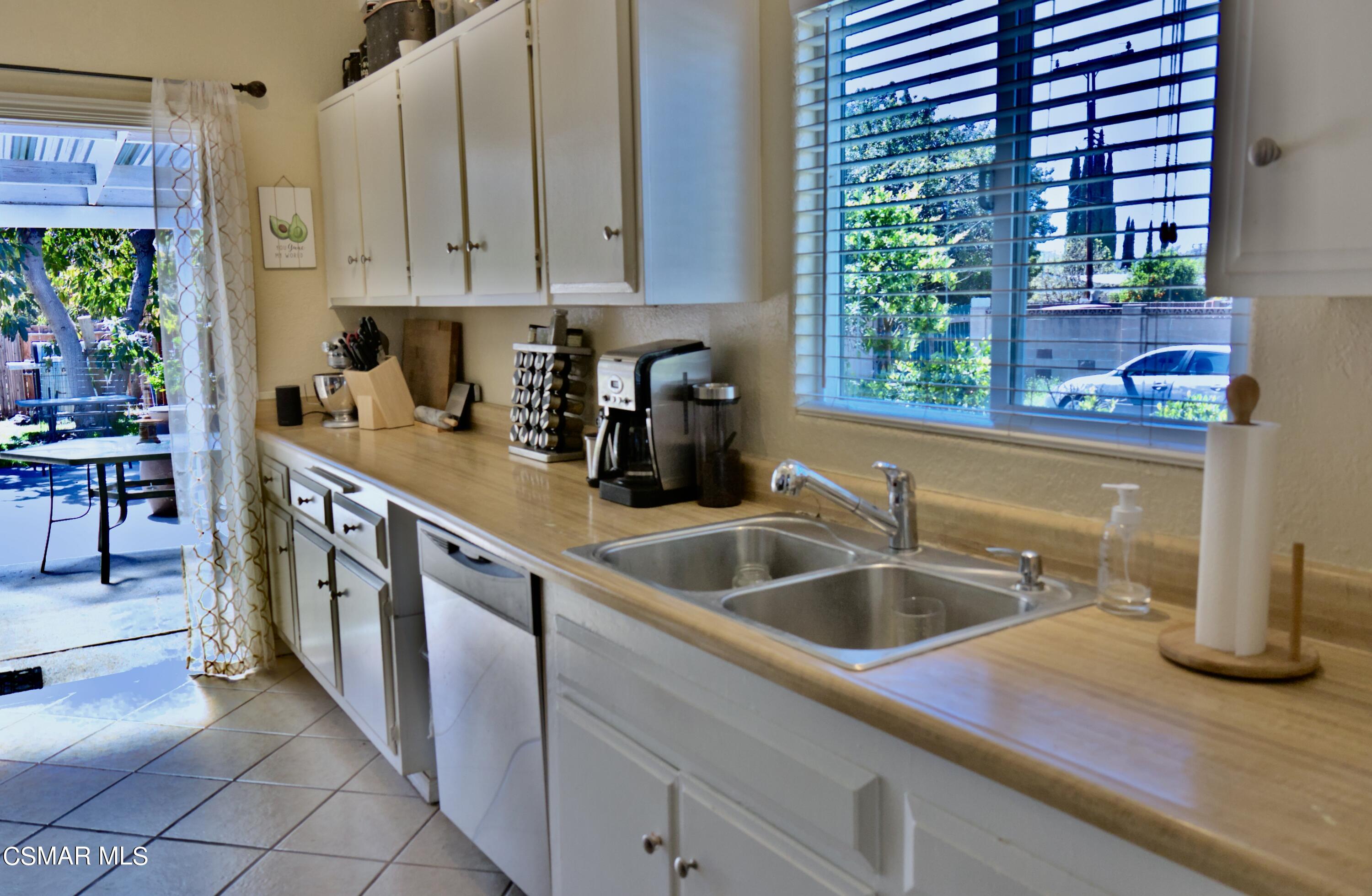 4306 Shopping Lane Simi Valley, CA 93063 - Photo 5 of 15 a kitchen with stainless steel appliances granite countertop a sink and a white wooden cabinets