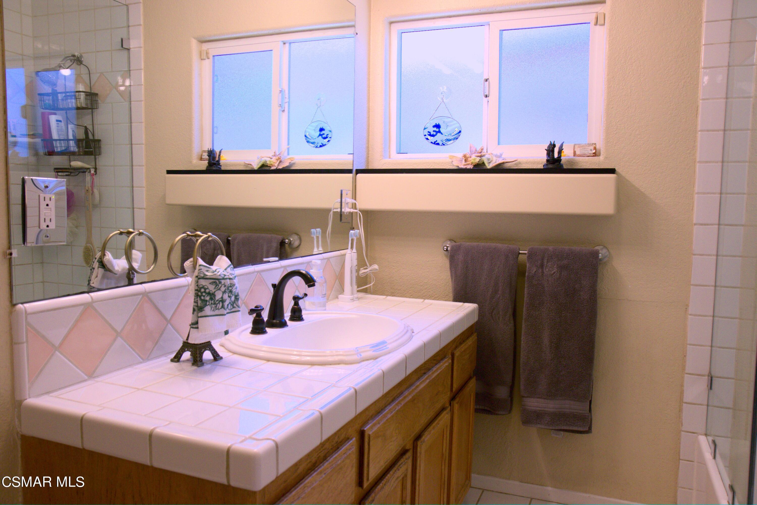 4306 Shopping Lane Simi Valley, CA 93063 - Photo 7 of 15 a bathroom with a sink and a mirror