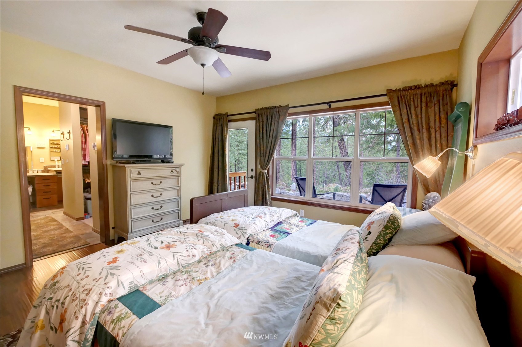 17 Highland Road Winthrop, WA 98862 - Photo 17 of 40 a bedroom with a bed flat screen tv and a large window