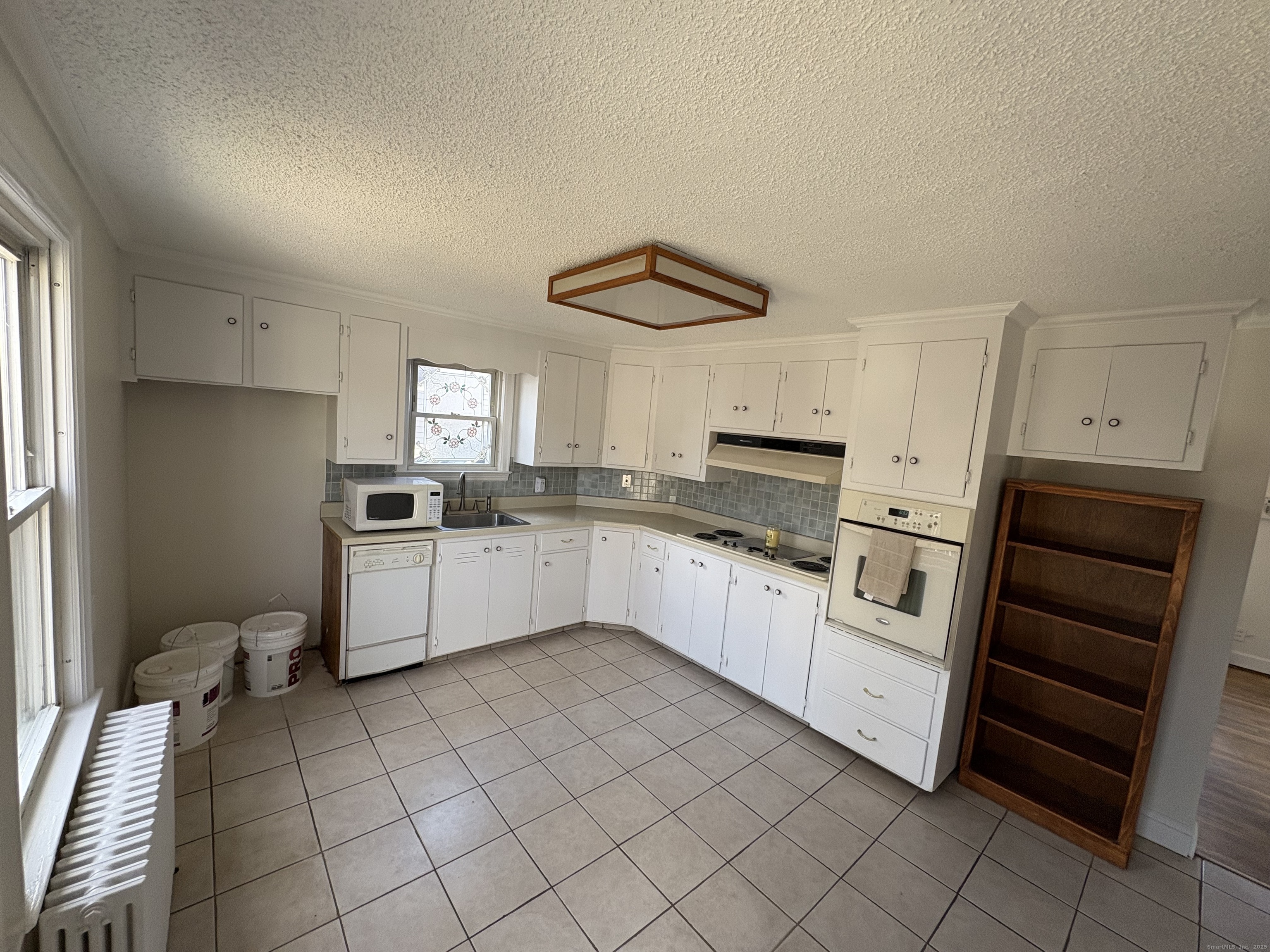 85 Benton Street Manchester, CT 06040 - Photo 7 of 34 a kitchen with granite countertop a refrigerator sink and cabinets
