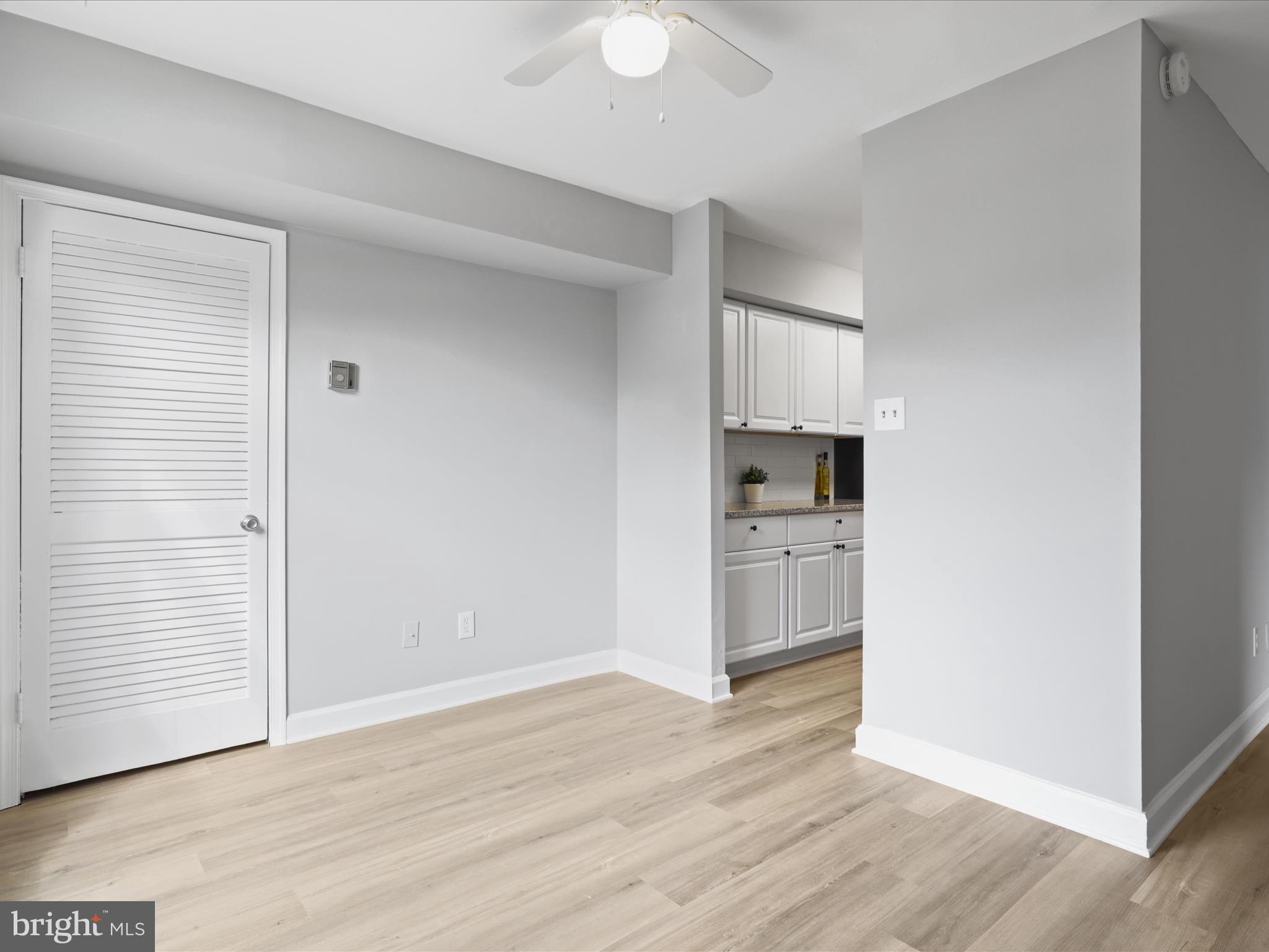 8316 Tobin Road, Unit 831611 Annandale, VA 22003 - Photo 11 of 41 an empty room with wooden floor & cabinet and a bathroom