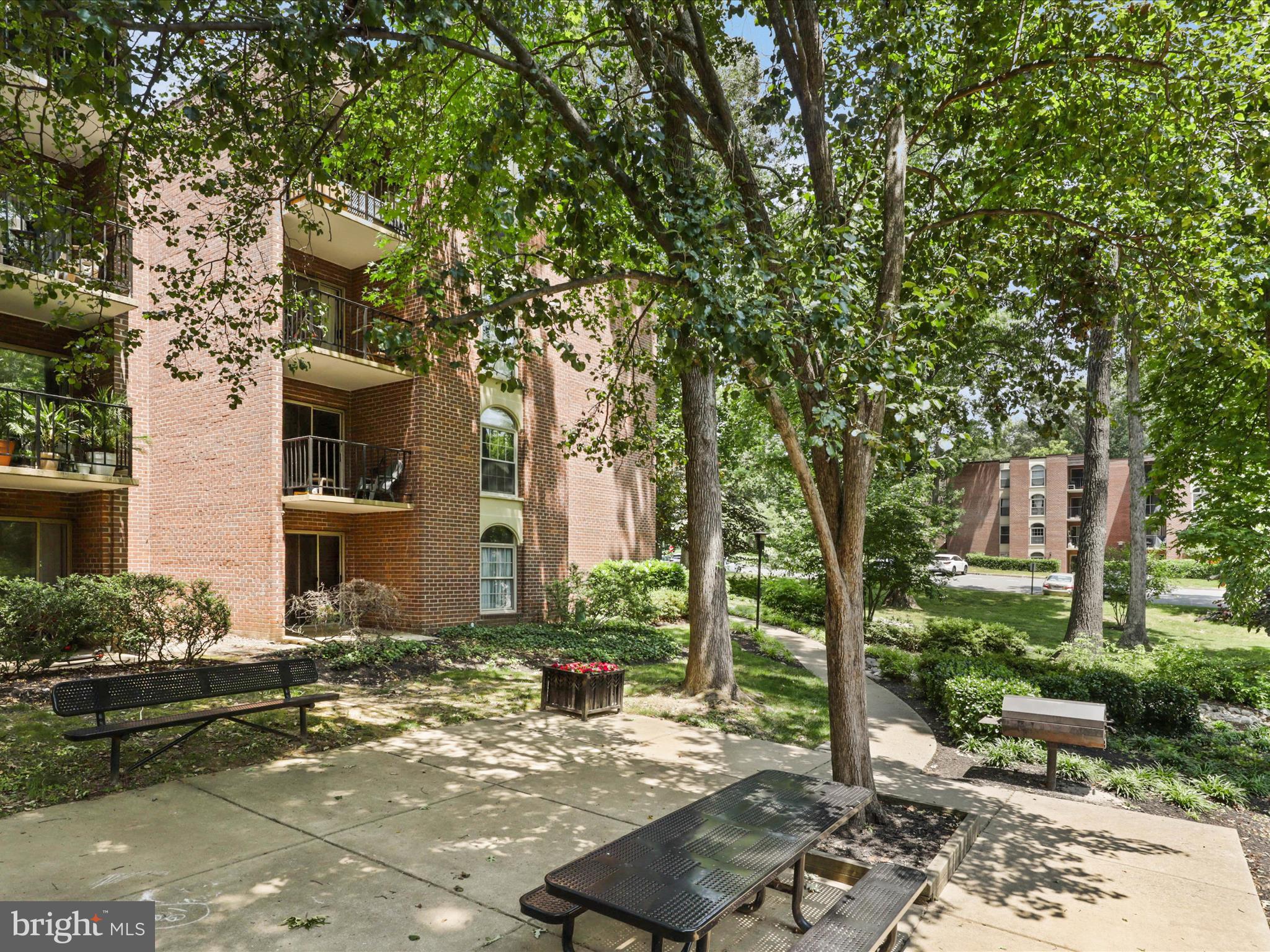 8316 Tobin Road, Unit 831611 Annandale, VA 22003 - Photo 24 of 41 a view of a patio with table and chairs and potted plants