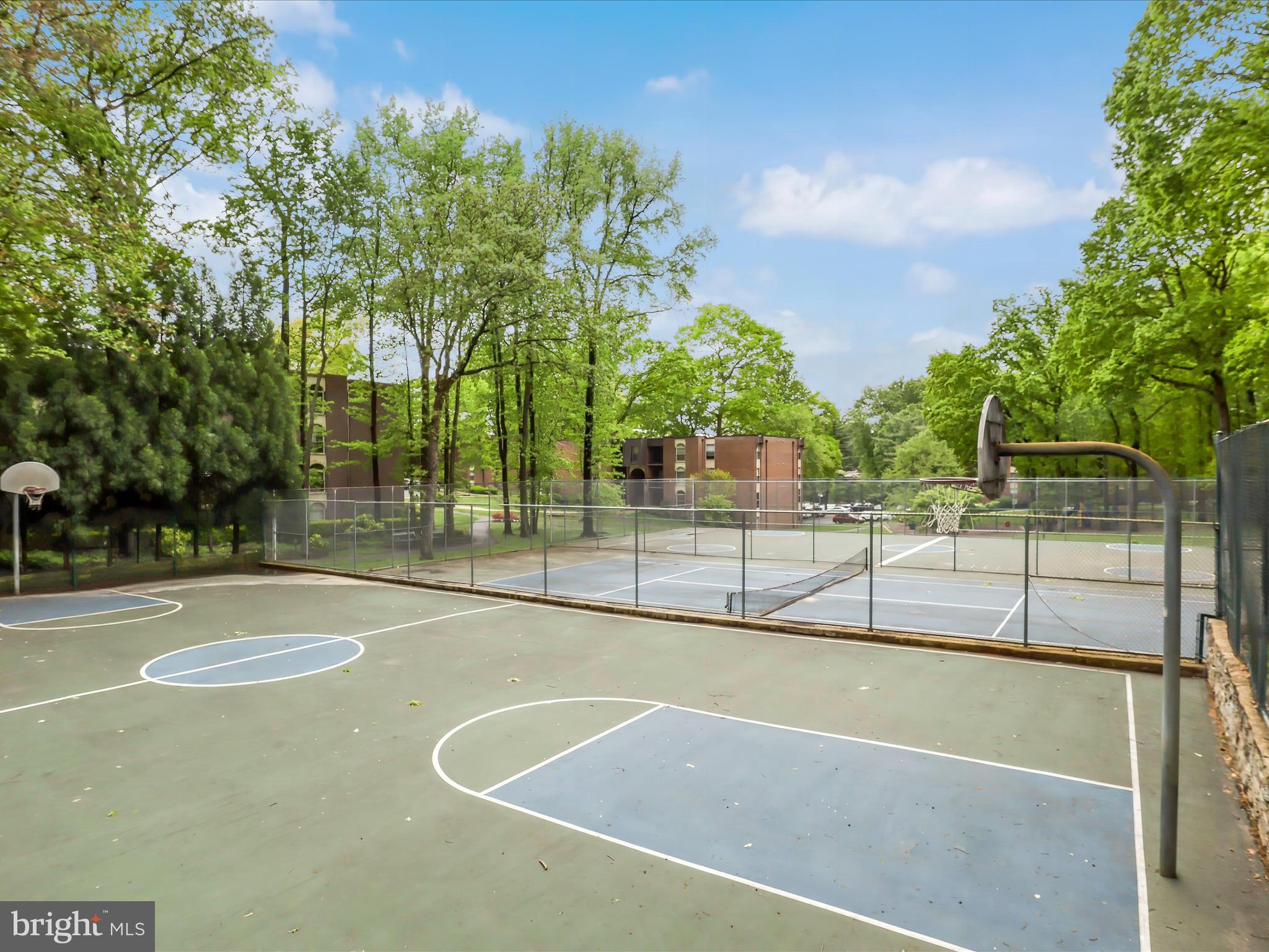 8316 Tobin Road, Unit 831611 Annandale, VA 22003 - Photo 27 of 41 a view of a tennis court with trees in the background