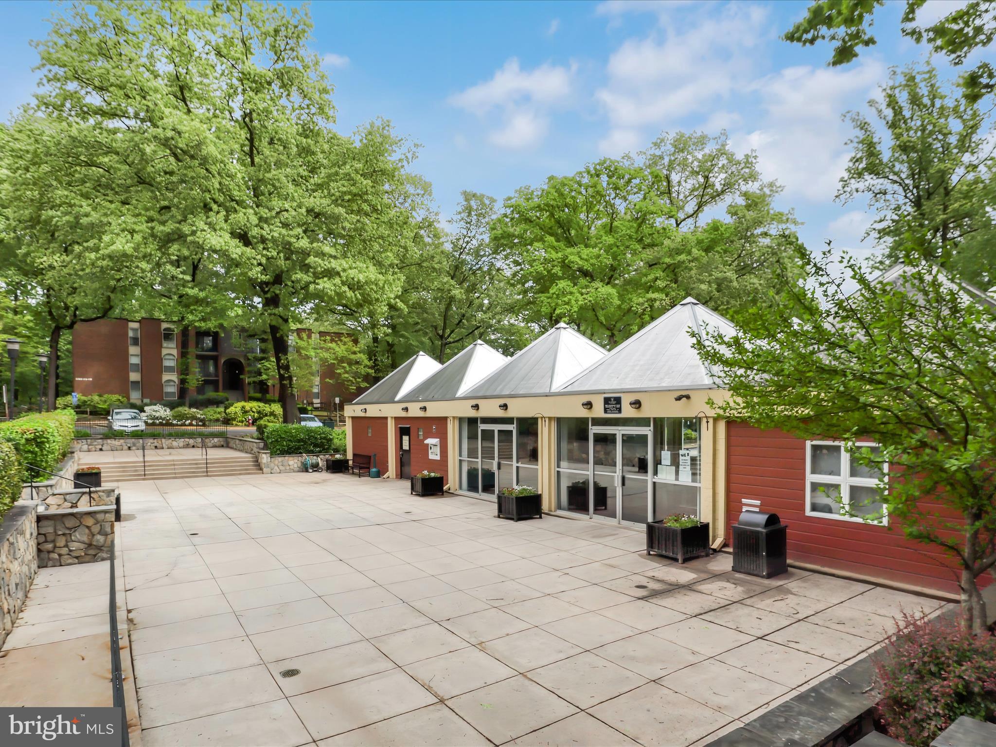 8316 Tobin Road, Unit 831611 Annandale, VA 22003 - Photo 35 of 41 a view of a white house with a chairs in a patio