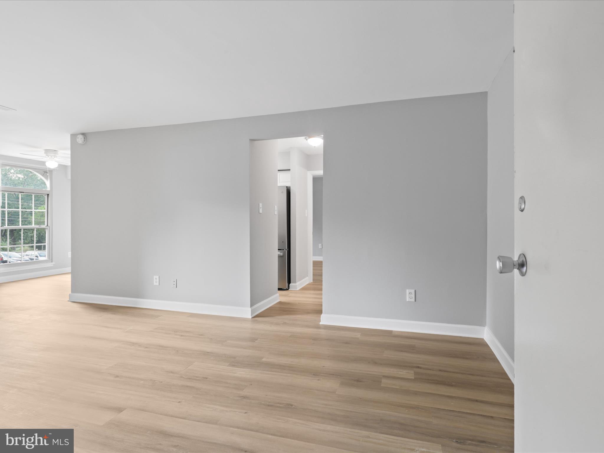 8316 Tobin Road, Unit 831611 Annandale, VA 22003 - Photo 6 of 41 a view of an empty room with wooden floor and a window
