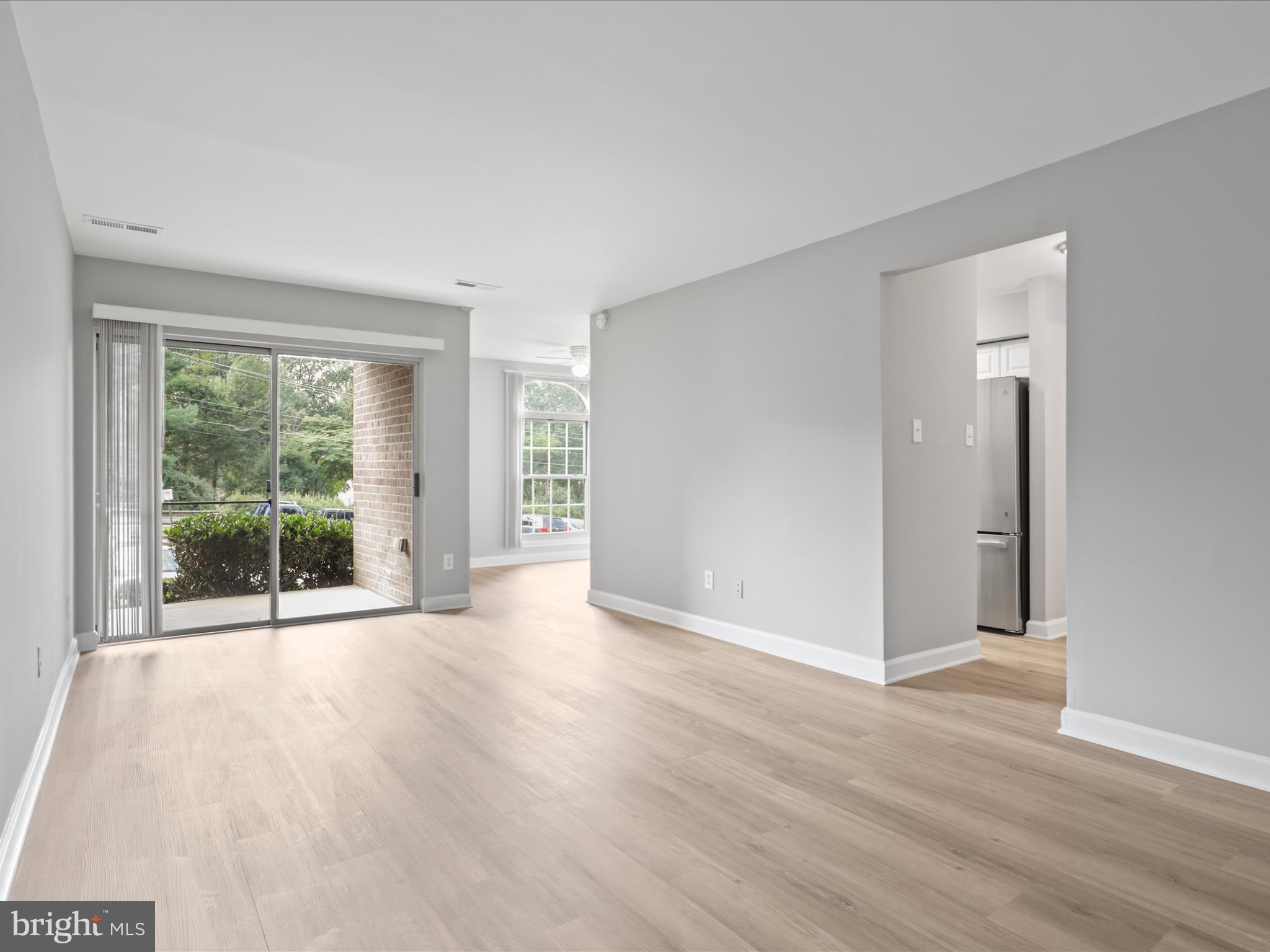 8316 Tobin Road, Unit 831611 Annandale, VA 22003 - Photo 7 of 41 a view of a big room with wooden floor and windows