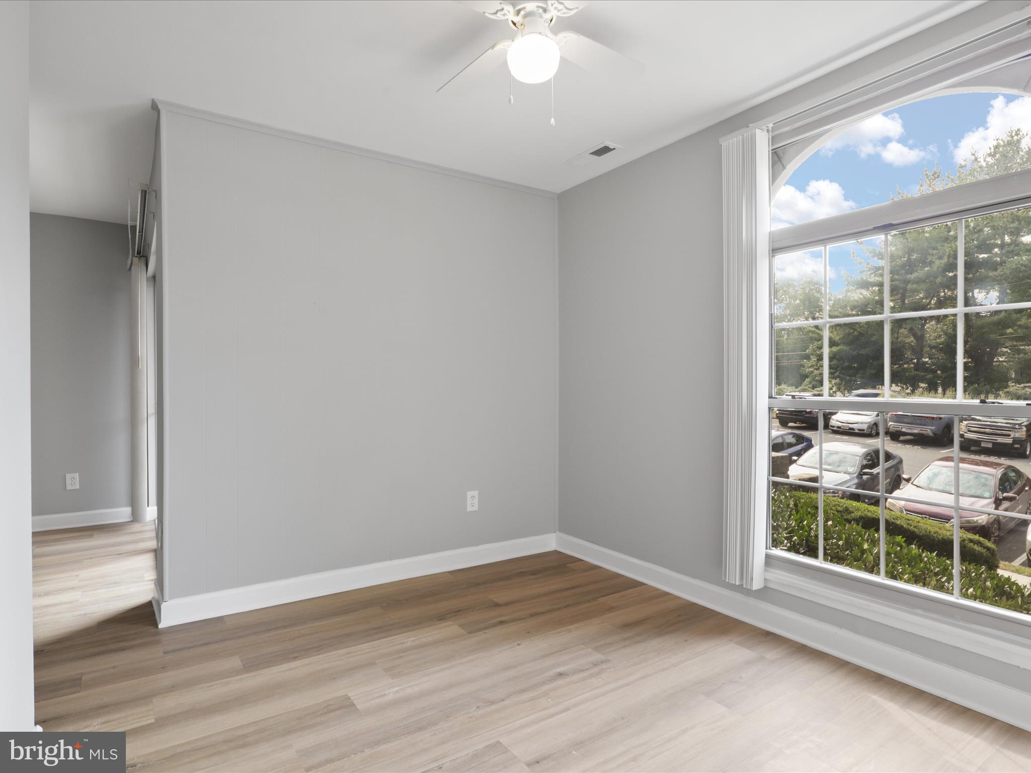 8316 Tobin Road, Unit 831611 Annandale, VA 22003 - Photo 10 of 41 an empty room with wooden floor and windows