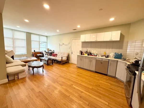 a open kitchen with stainless steel appliances granite countertop a stove and a refrigerator