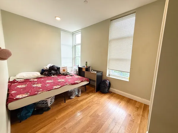 a bedroom with a bed and a window