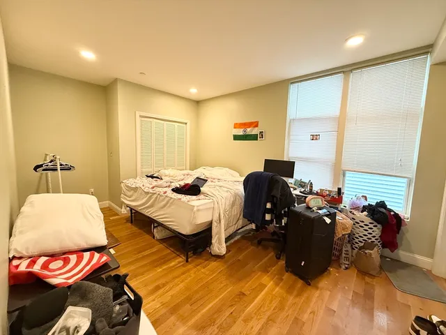 a bedroom with furniture and a wooden floor