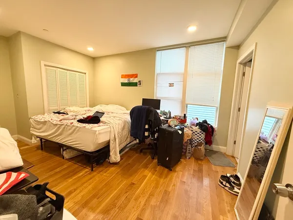 a bed room with a bed and a chair