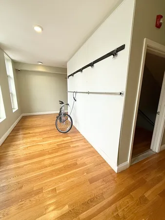 a view of a room with wooden floor and cabinet