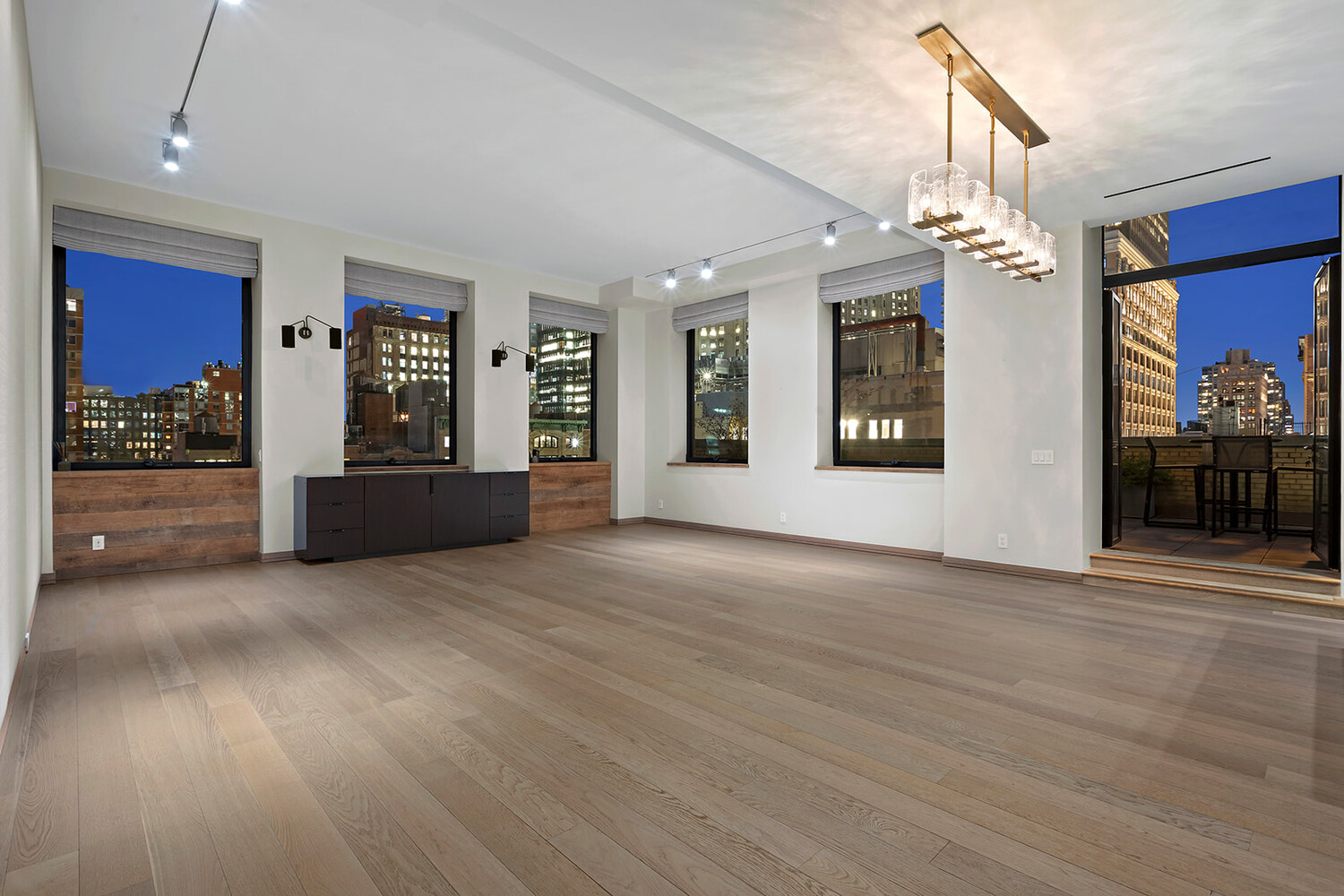 88 Lexington Avenue, Unit 1506 Manhattan, NY 10010 - Photo 4 of 16 a view of an empty room with a fireplace and a chandelier