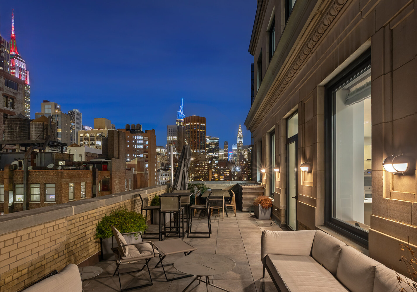 88 Lexington Avenue, Unit 1506 Manhattan, NY 10010 - Photo 5 of 16 a view of a balcony with chairs and potted plants