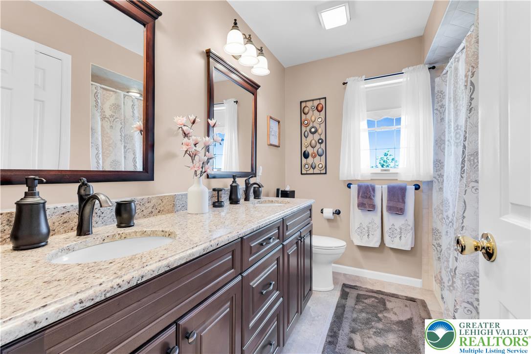 4059 Old Sentry Road Allentown, PA 18104 - Photo 28 of 39 Granite counters and ample storage define this well-appointed bathroom.