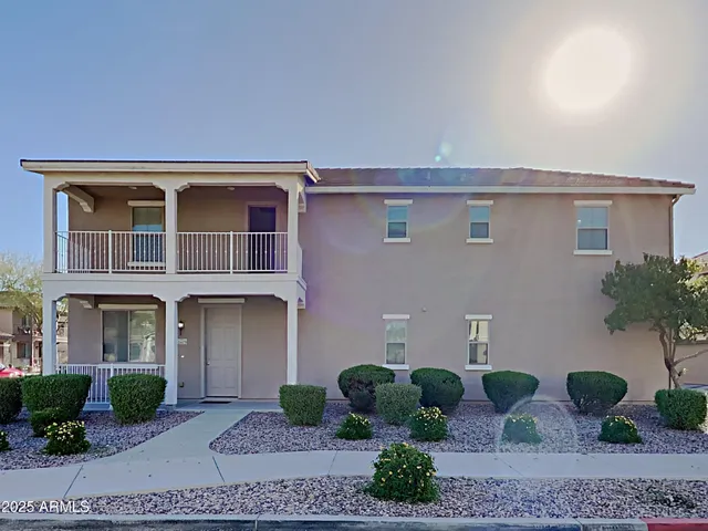 a front view of a house with plants