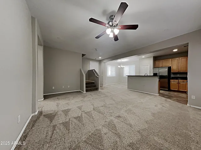 a view of a livingroom with a stove and kitchen view