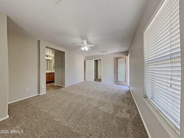 a view of empty room with window and fireplace