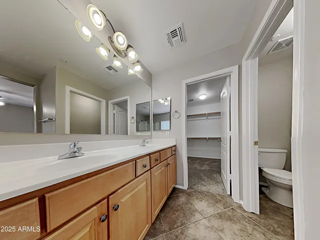 a bathroom with a double vanity sink and a mirror