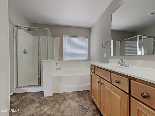a bathroom with a tub sink and mirror