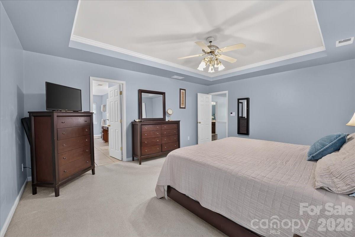 8006 Fine Robe Drive Indian Trail, NC 28079 - Photo 25 of 36 a spacious bedroom with a bed and a flat screen tv