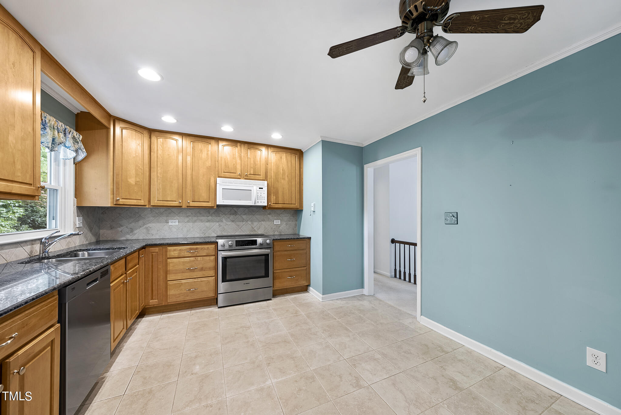 5213 Old Forge Circle Raleigh, NC 27609 - Photo 15 of 37 a large kitchen with a large window appliances and cabinets