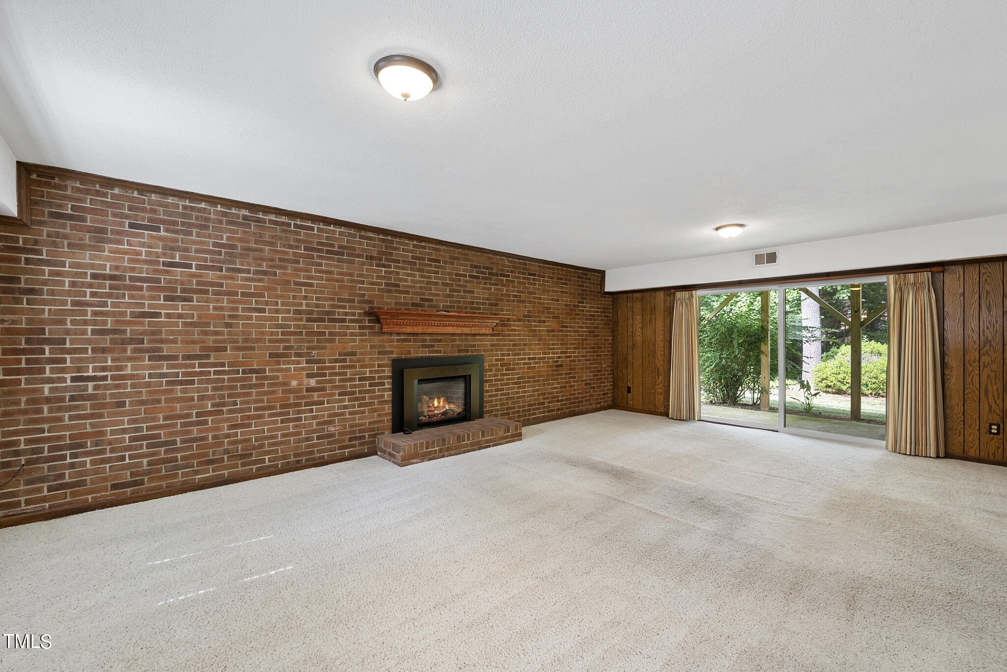 5213 Old Forge Circle Raleigh, NC 27609 - Photo 22 of 37 a view of an empty room with a fireplace and a window