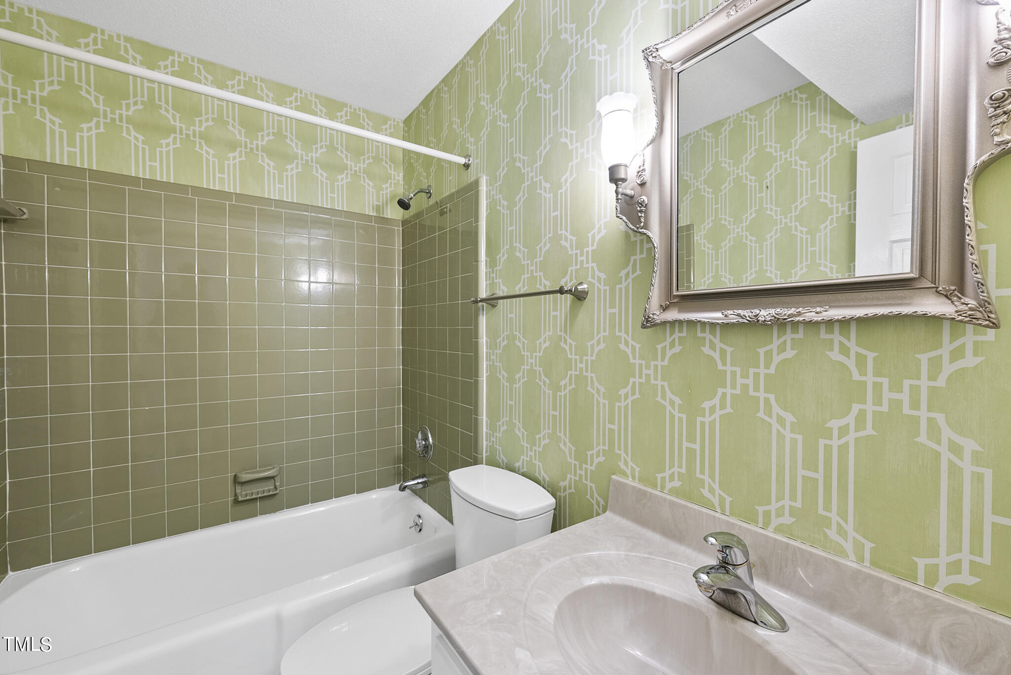 5213 Old Forge Circle Raleigh, NC 27609 - Photo 31 of 37 a bathroom with a sink and mirror with bathtub