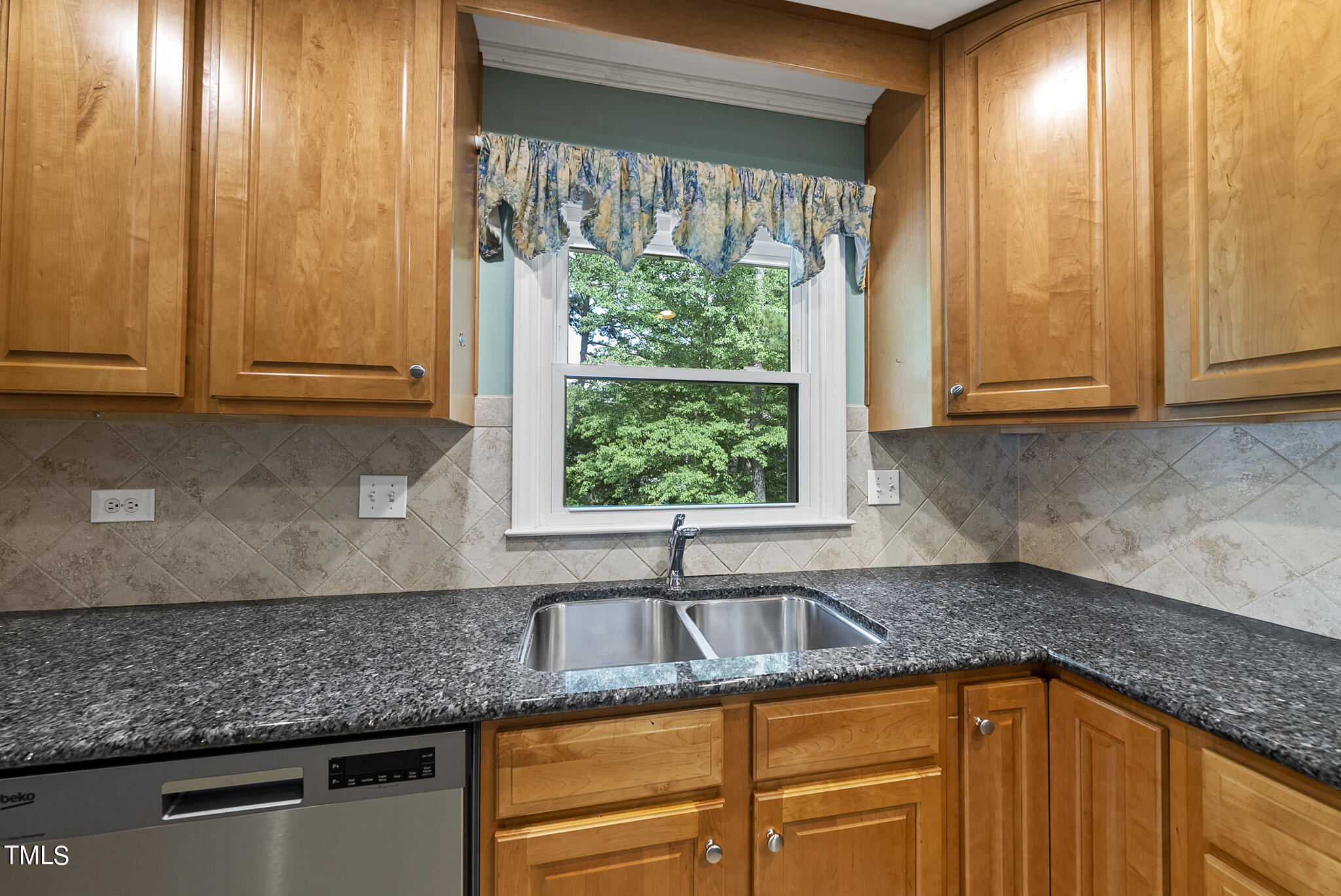 5213 Old Forge Circle Raleigh, NC 27609 - Photo 5 of 37 a kitchen with granite countertop cabinets sink and large window