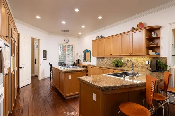 a kitchen with a sink appliances and cabinets