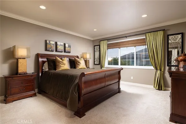 a bedroom with a large bed and a large window