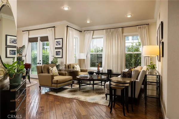a living room with furniture and floor to ceiling windows