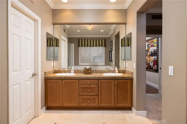 a view of a kitchen with granite countertop a sink and cabinets