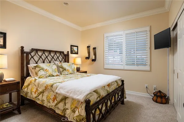 a bedroom with a bed a couch and a window