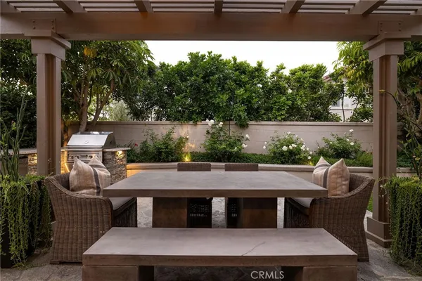 a view of a patio with table and chairs and potted plants