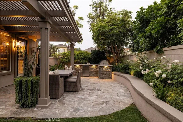 a view of a patio with chairs and potted plants