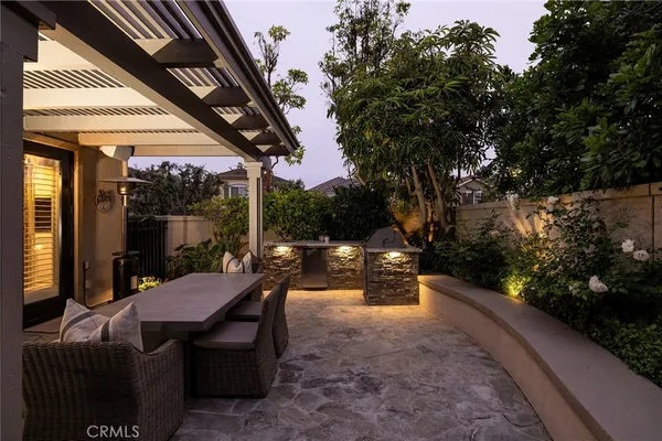 a view of a patio with a table chairs and a backyard