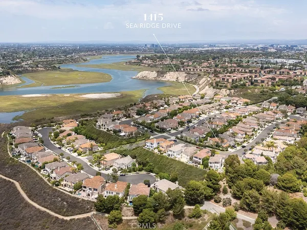 an aerial view of residential building and lake