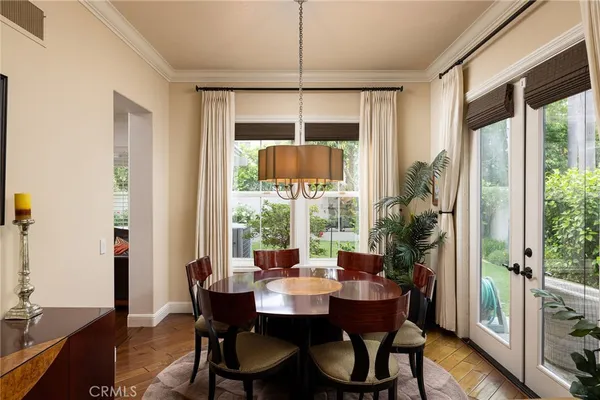 a dining room with furniture window and wooden floor