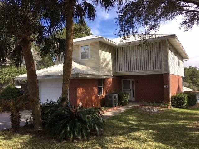 95 Blue Lake Road Santa Rosa Beach, FL 32459 - Photo 2 of 11 a front view of a house with a yard